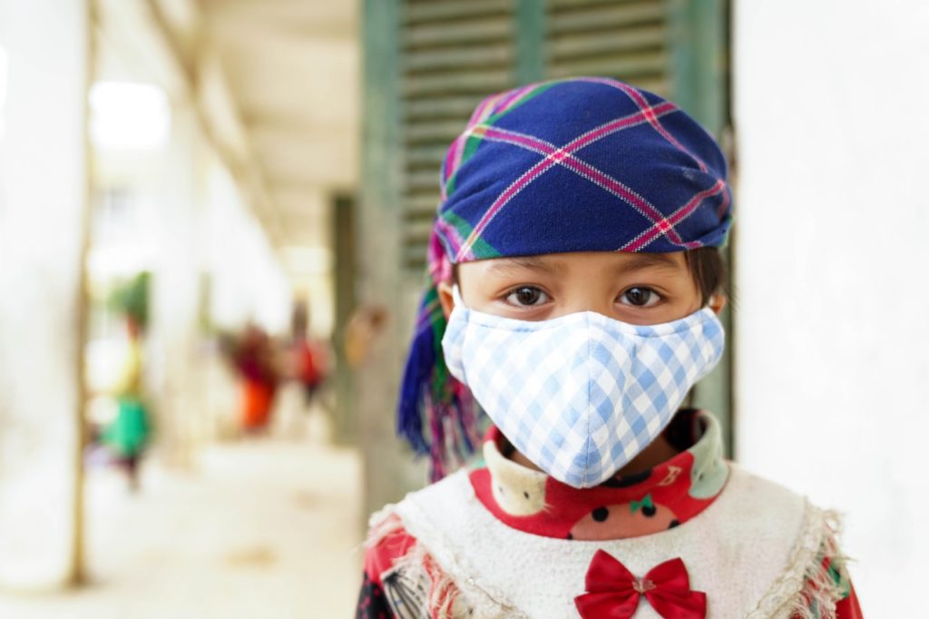 A young girl wears a mask to stop the spread of covid-19 in vietnam