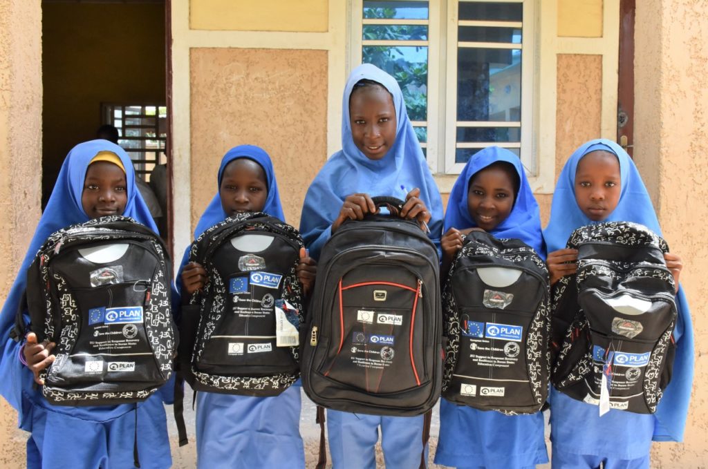 Girls receive their new school kits from Plan International