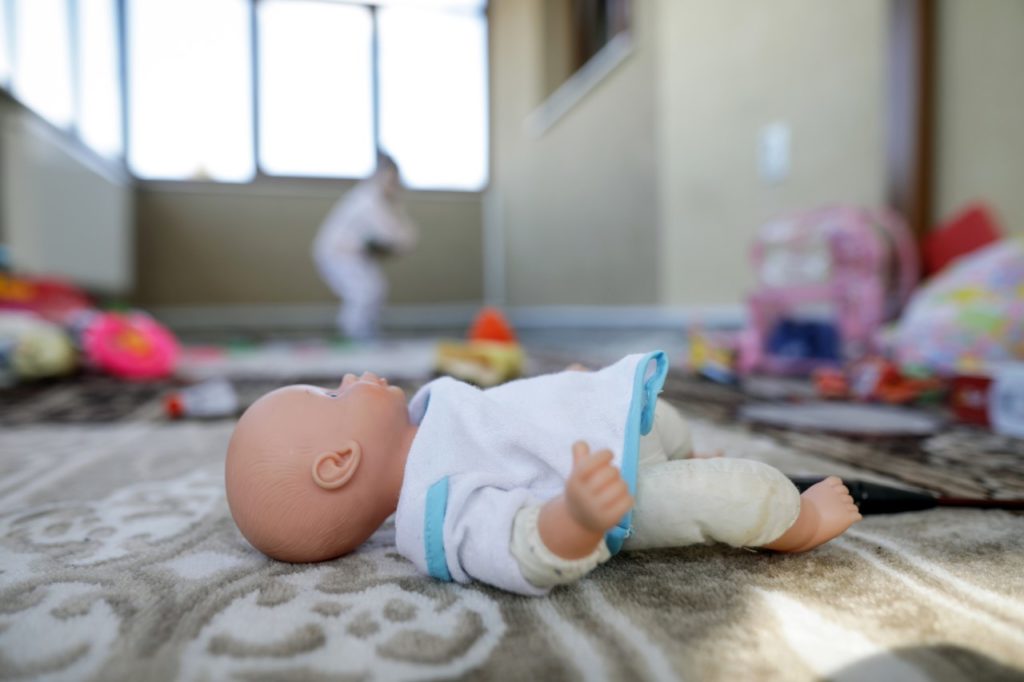A doll on the floor of a shelter in Romania