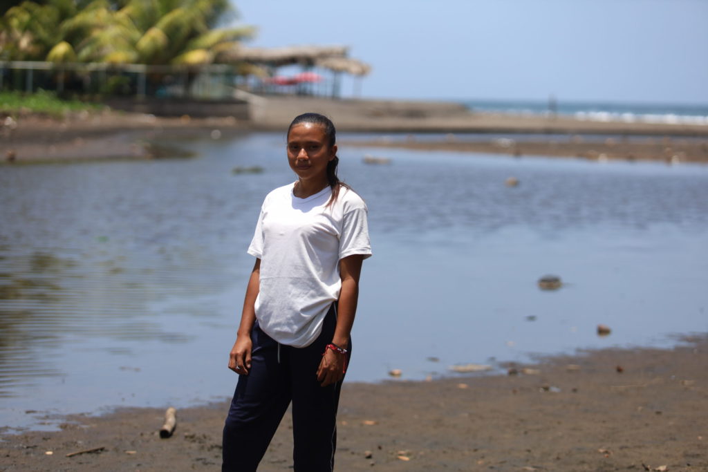 Young woman standing by water