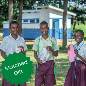 Children from a school in Uganda hold period pads they've sewn