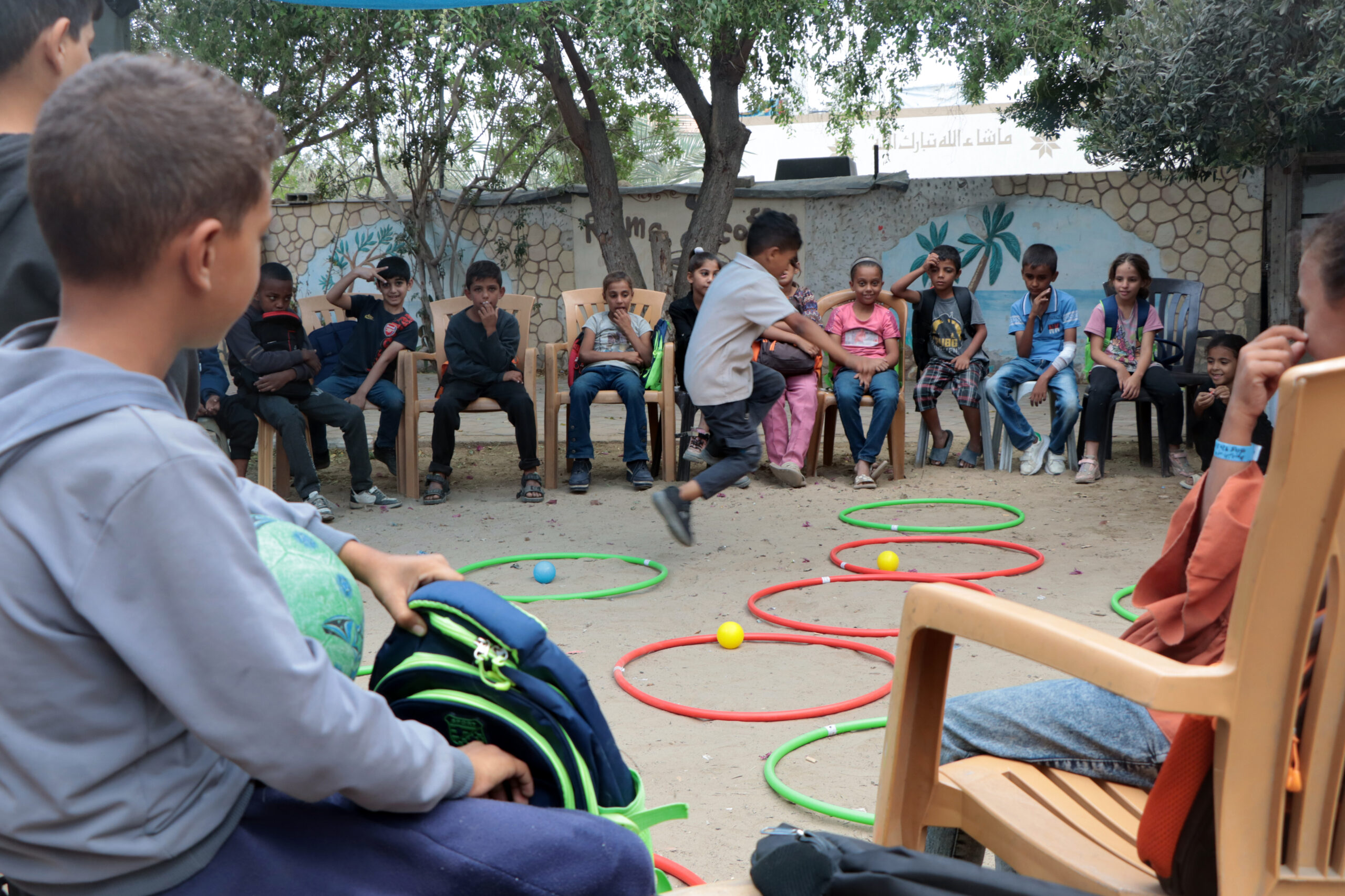 Children playing games at a learning space in Gaza