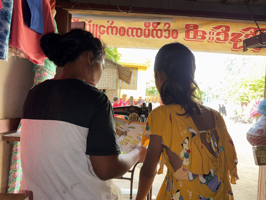 Two women speak together