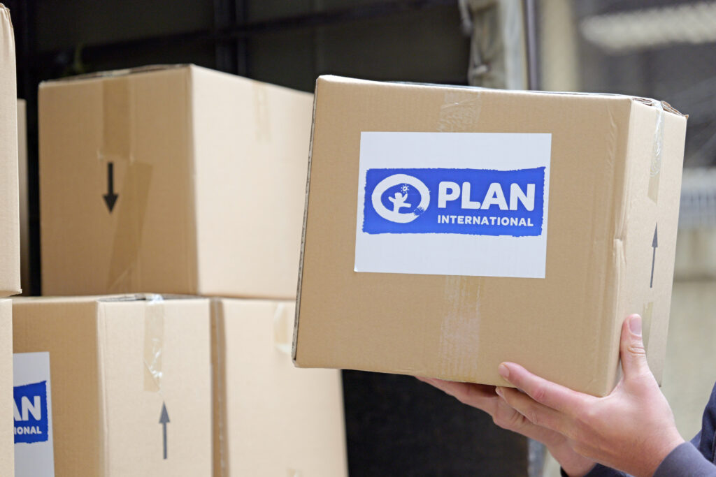 A food box with Plan International's logo on it